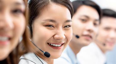 A row of customer representatives wearing headsets